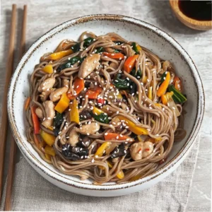 Chicken stir-fry with Chinese noodles and wok vegetables garnished with chopped peanuts