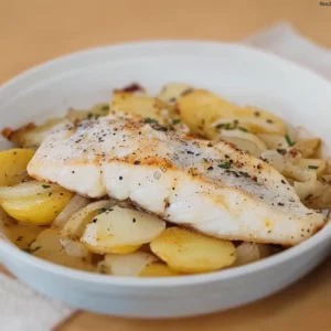 Mediterranean-style baked sea bass with potatoes and onions in white wine